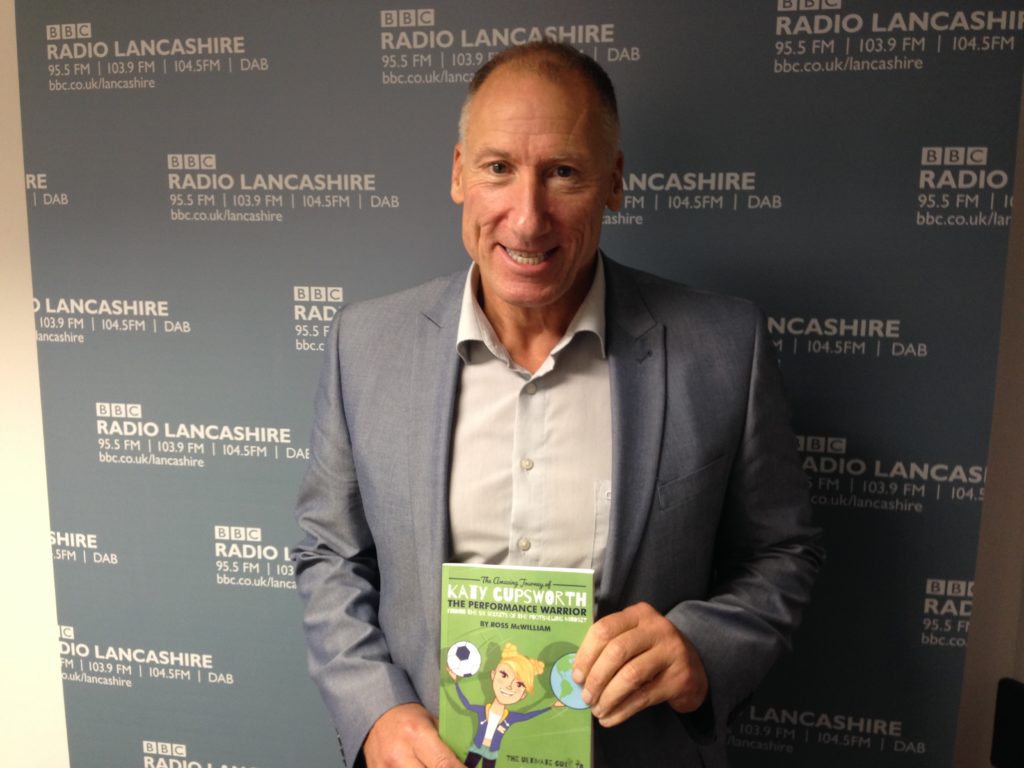 Ross McWilliam holding his book