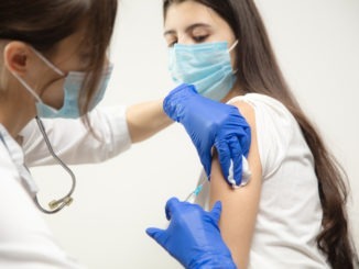 Close up doctor or nurse giving vaccine to patient using the syringe injected in hospital