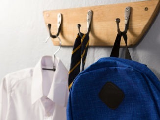School uniform and schoolbag hanging on hook
