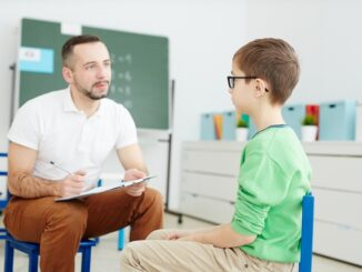 Teacher talking to young pupil