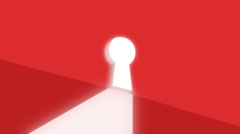 Bright light shining through a keyhole door with red wall background