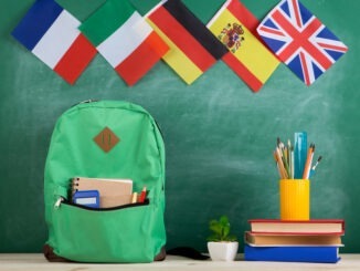 backpack, flags of Spain, France, Great Britain and other countries, books and school supplies of the blackboard