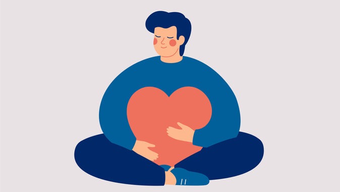 Young man embraces a big red heart with mindfulness and love.