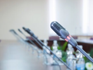 close up of a microphone in empty conference hall