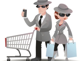 Mystery shopper man with shopping cart and mobile phone and woman with bags in sunglasses, spy coats and hats
