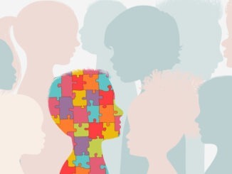 Autism syndrome concept. Jigsaw Puzzle that forms the head of a child s profile With other children background.