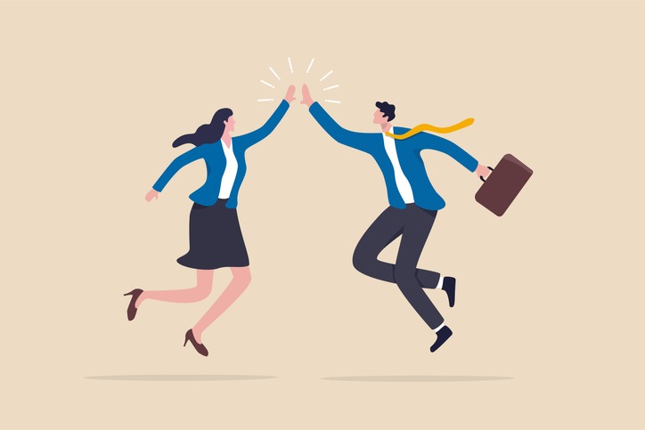 happy businessman and woman teamwork coworkers jumping and hi five clapping hands.