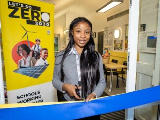 Pupil cuts ribbon to signify the star of the IKEA Let's go zero competition for schools