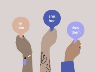 Hands holding pads with pronoun variations, gender equality, pride month