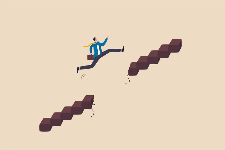 challenge and risk to success and win business competition concept, ambitious businessman jump pass broken stair gap to reach target.