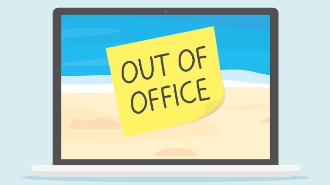 out of office written on sticky note on laptop screen with sandy beach landscape as a screensaver