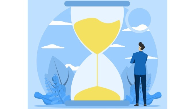 Business time concept, Bearded businessman standing and looking at hourglass while time flies. Patience, delay and tolerance 