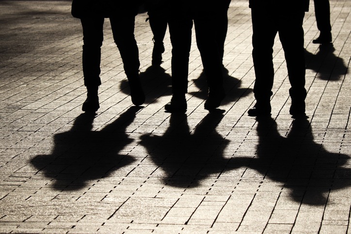 Silhouettes and shadows of people on the street