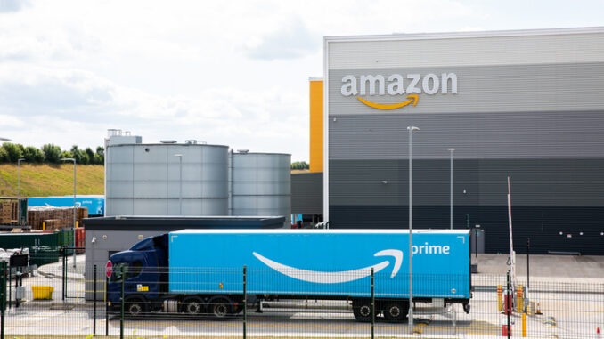 An Amazon Prime truck arriving at an Amazon warehouse