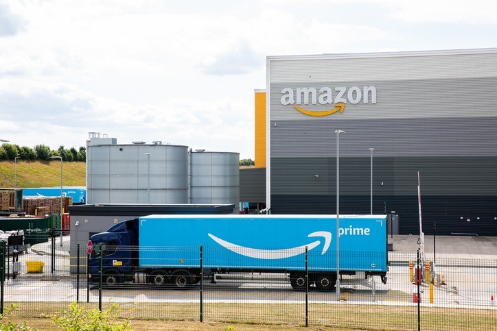 An Amazon Prime truck arriving at an Amazon warehouse