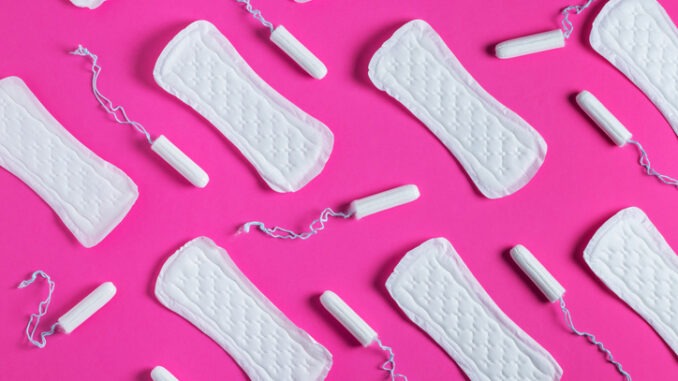 Tampons, feminine sanitary pads pattern on pink background. Hygiene care during critical days. Menstrual cycle. Caring for women's health. Monthly protection.