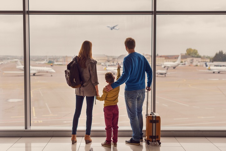 Family looking out window at airport