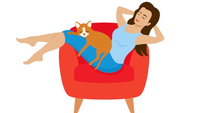 Young woman relaxing in armchair with cat