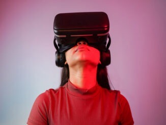 Young Asian Indian woman wearing virtual reality headset, a girl with VR glasses concept studio portrait