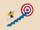 Business progress or career path, step to reach target or business goal, success step or motivation for improvement concept, confidence businesswoman carrying arrow walk up stair to reach target.