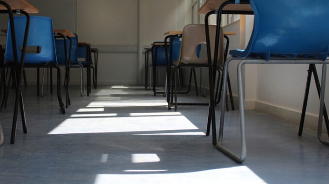 Low angled view of an empty classroom with sunlight