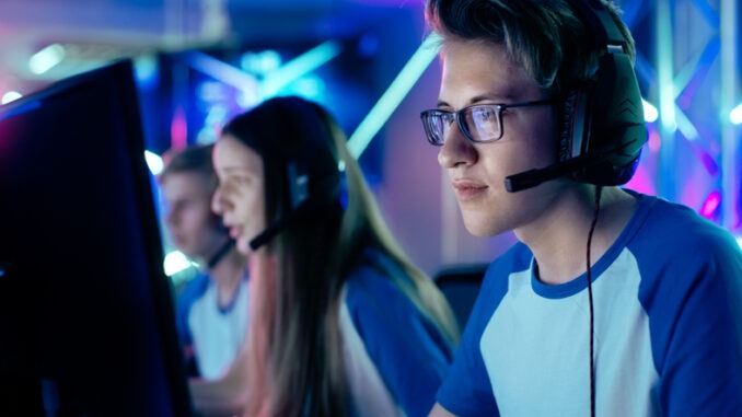 Team of Teenage Gamers Play in Multiplayer  Video Game on a eSport Tournament. 