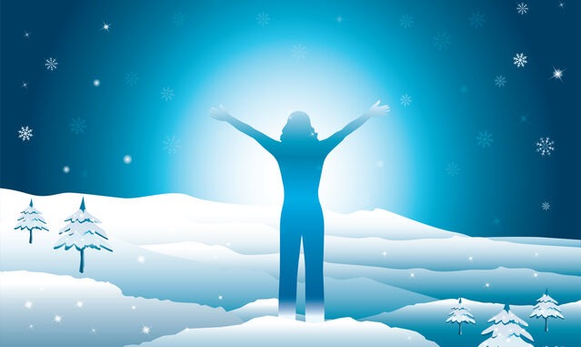 Happy woman with hands up on the top of snowy mountains.