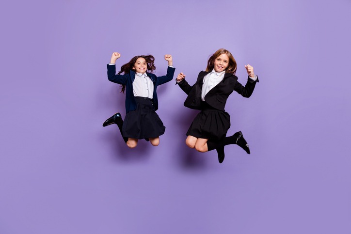 cute cheerful kids raise fists isolated over purple violet background