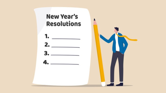 New year's resolutions, set goal or business target for new year or beginning with work challenge concept, smart businessman holding big pencil thinking about new year's resolution on notepad paper.