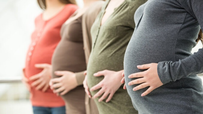 Pregnant women lined up in a row 