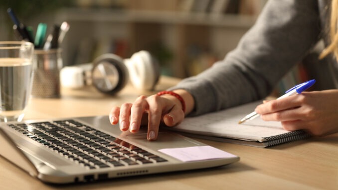 hands completing and checking a report