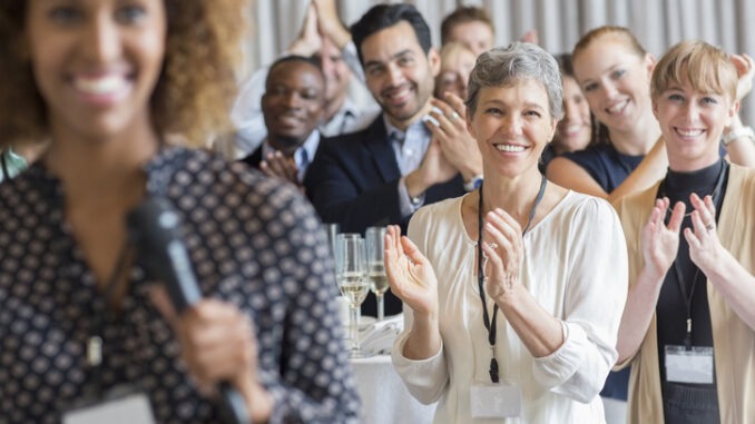 Group of people applauding after speech during conference