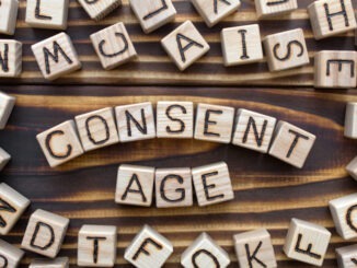 consent age wooden cubes with letters, sexual education