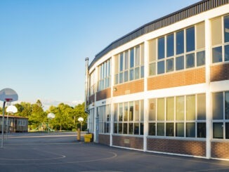 School building and school yard with basketball court