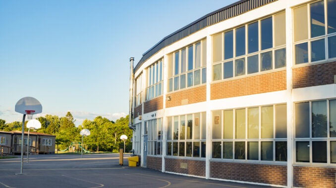 School building and school yard with basketball court