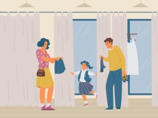 Parents With Daughter Choosing School Uniform In Clothes Store.