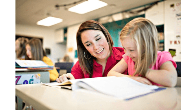 Teacher helping child with schoolwork
