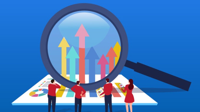 Businessman uses magnifying glass to change data arrow direction