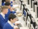 Teenage students using computers in computer room
