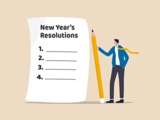 New year's resolutions, set goal or business target for new year or beginning with work challenge concept, smart businessman holding big pencil thinking about new year's resolution on notepad paper.