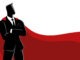 Businessman as a superhero, wearing a magnificent red cape and posing gallantly with arms crossed. Symbolize confidence, strength, and exceptional leadership in the corporate world