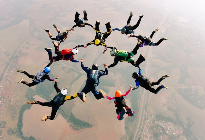 Skydivers holding hands making a fomation. High angle view.