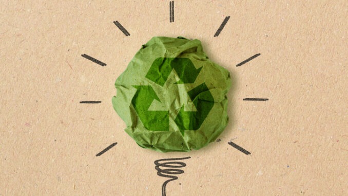 Light bulb drawing with recycling sign on crumpled recycled paper - Concept of ecology and recycling