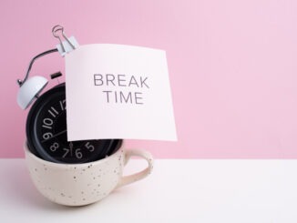 Break time. Coffee and clock on a colored background. Time to drink coffee. Creative idea.