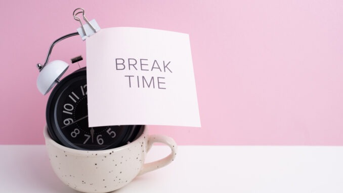 Break time. Coffee and clock on a colored background. Time to drink coffee. Creative idea.