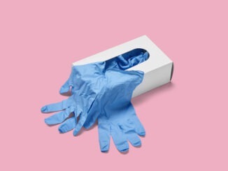 close up of a box of white latex protective gloves on white background