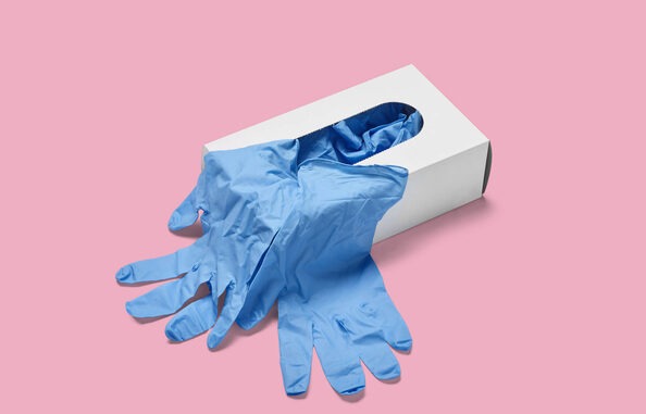 close up of a box of white latex protective gloves on white background