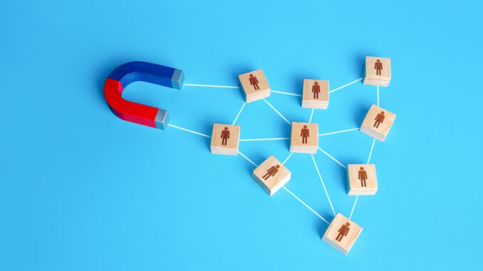 The magnet attracts a network of connected blocks of people. Attracting new customers based on recommendations and good reviews. Recruitment of entire formed teams of employees. Business team building