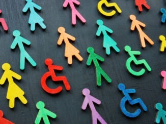 Colorful figurines on the dark surface. Diversity and inclusion concept.