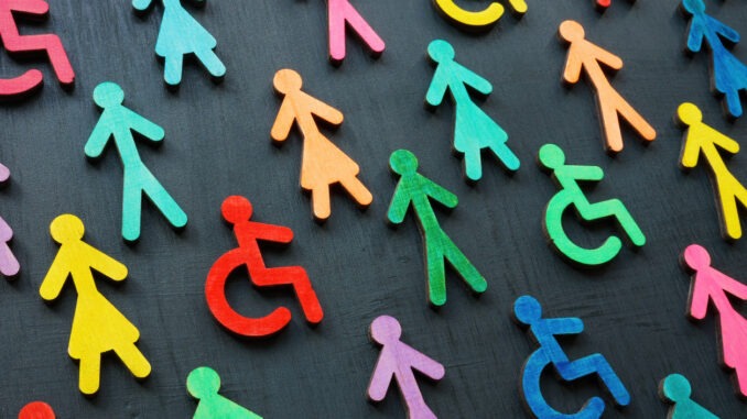 Colorful figurines on the dark surface. Diversity and inclusion concept.